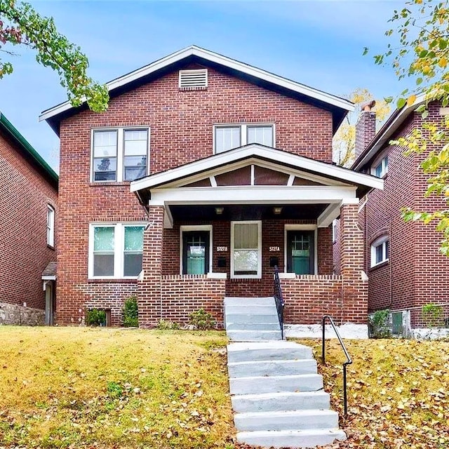 5727 Dewey Ave, Saint Louis, MO 63116 - view of front of house with brick siding, covered porch, a front lawn, and stairs