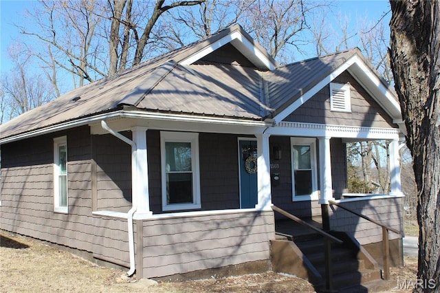 view of front of property featuring a porch and metal roof