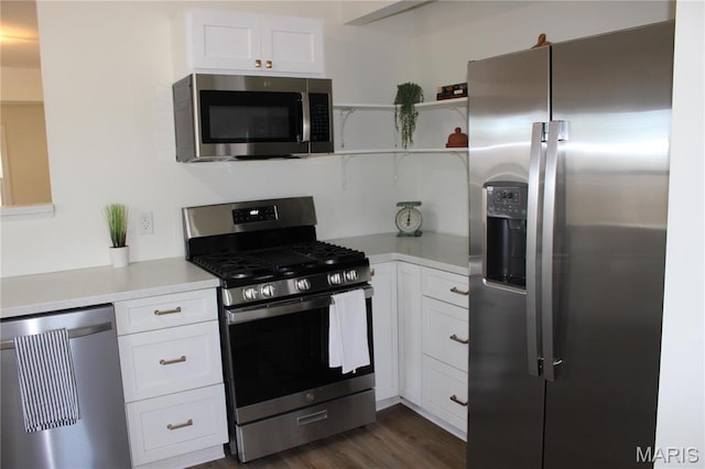kitchen with stainless steel appliances, light countertops, and white cabinetry