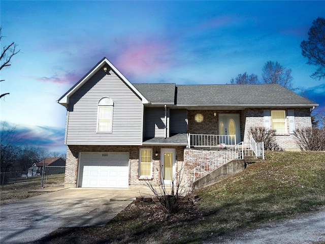 9606 Drawbridge Ln, Hillsboro, MO 63050 - view of front facade with an attached garage, brick siding, concrete driveway, fence, and roof with shingles