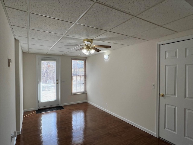 9606 Drawbridge Ln, Hillsboro, MO 63050 - spare room featuring a drop ceiling, ceiling fan, dark wood-style floors, and baseboards