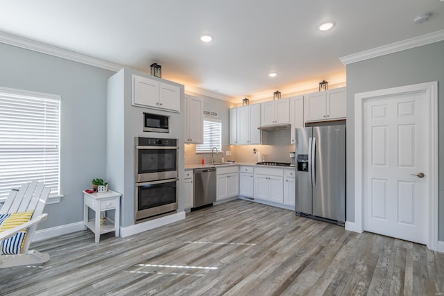 24345 State Rte Ww Unit 46, Saint Genevieve, MO 63670 - kitchen featuring stainless steel appliances, crown molding, light countertops, light wood-type flooring, and decorative backsplash