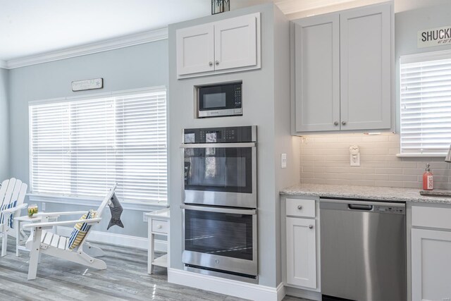 24345 State Rte Ww Unit 46, Saint Genevieve, MO 63670 - kitchen featuring stainless steel appliances, backsplash, wood finished floors, crown molding, and baseboards