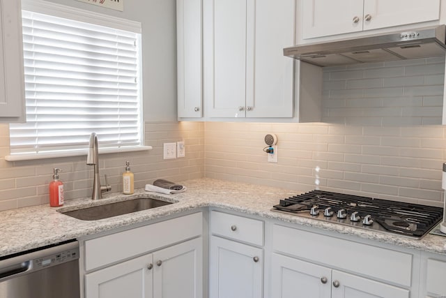 24345 State Rte Ww Unit 46, Saint Genevieve, MO 63670 - kitchen featuring under cabinet range hood, appliances with stainless steel finishes, a sink, decorative backsplash, and white cabinets