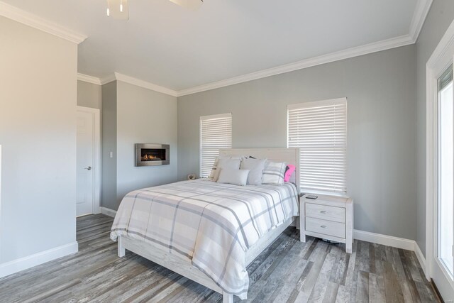 24345 State Rte Ww Unit 46, Saint Genevieve, MO 63670 - bedroom featuring baseboards, crown molding, wood finished floors, and a fireplace