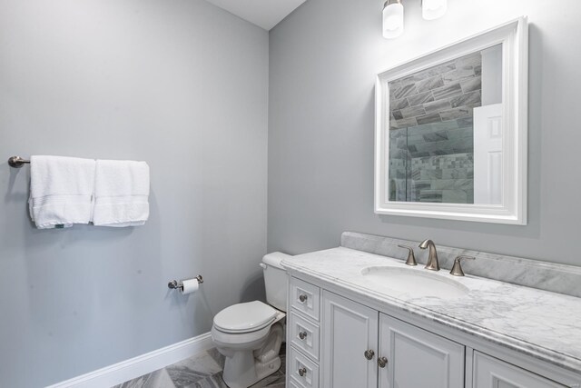 24345 State Rte Ww Unit 46, Saint Genevieve, MO 63670 - bathroom with marble look tile flooring, tiled shower, vanity, toilet, and baseboards