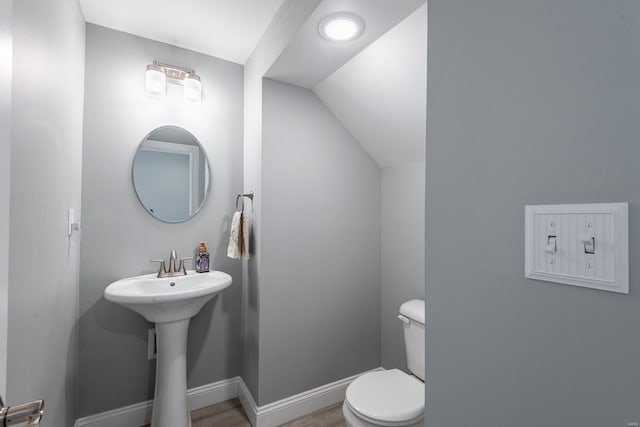 24345 State Rte Ww Unit 46, Saint Genevieve, MO 63670 - half bath featuring toilet, vaulted ceiling, wood finished floors, and baseboards