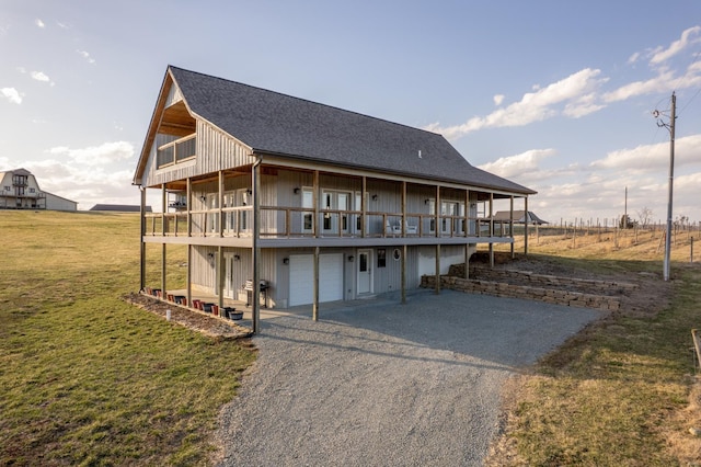 24345 State Rte Ww Unit 46, Saint Genevieve, MO 63670 - back of property featuring asphalt driveway, a garage, a lawn, a shingled roof, and a deck