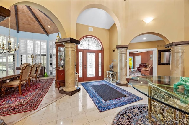 651 Kiefer Creek Rd, Ballwin, MO 63021 - entrance foyer featuring decorative columns, high vaulted ceiling, arched walkways, tile patterned floors, and a chandelier