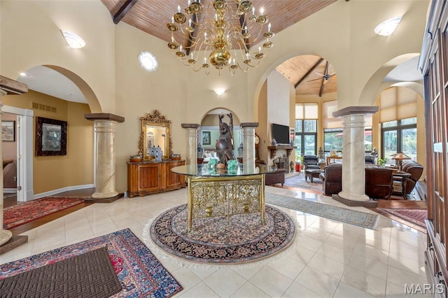 651 Kiefer Creek Rd, Ballwin, MO 63021 - entryway with decorative columns, high vaulted ceiling, arched walkways, wood ceiling, and baseboards