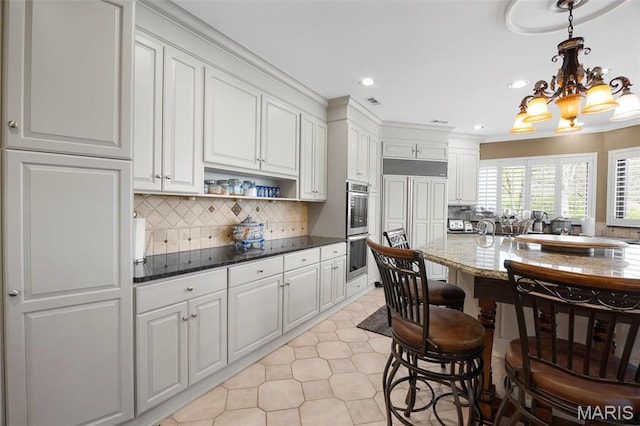 651 Kiefer Creek Rd, Ballwin, MO 63021 - kitchen featuring double oven, white cabinets, tasteful backsplash, recessed lighting, and dark stone countertops