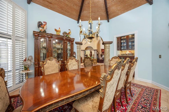 651 Kiefer Creek Rd, Ballwin, MO 63021 - tiled dining room featuring a chandelier, wooden ceiling, high vaulted ceiling, decorative columns, and baseboards