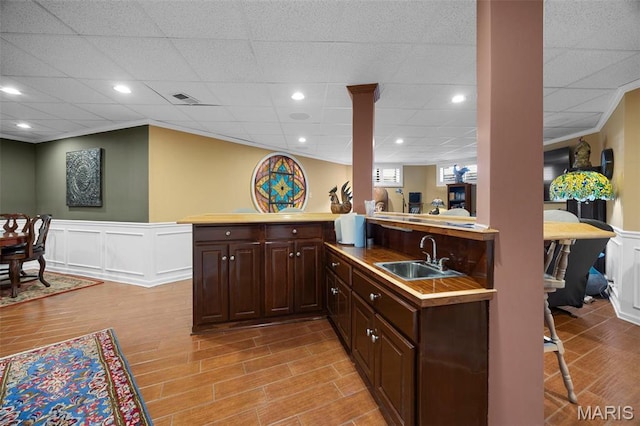 651 Kiefer Creek Rd, Ballwin, MO 63021 - indoor wet bar with a decorative wall, a wainscoted wall, light wood-style floors, and a paneled ceiling