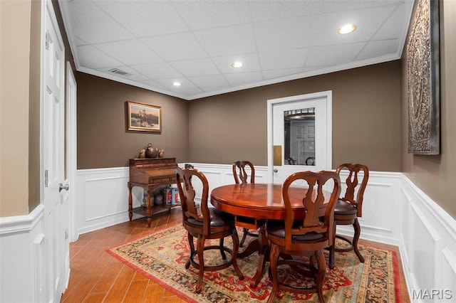651 Kiefer Creek Rd, Ballwin, MO 63021 - dining space with wainscoting, a decorative wall, ornamental molding, wood finished floors, and recessed lighting
