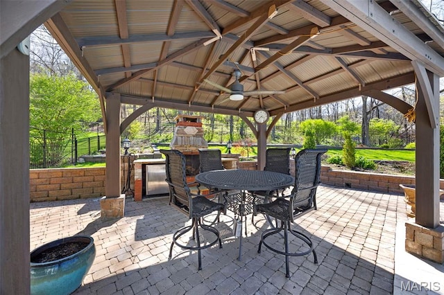 651 Kiefer Creek Rd, Ballwin, MO 63021 - view of patio featuring a gazebo, a fireplace, outdoor dining area, fence, and ceiling fan
