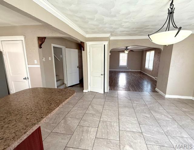 19 S Schlueter Ave, Saint Louis, MO 63135 - unfurnished dining area featuring ceiling fan, arched walkways, stairway, and crown molding