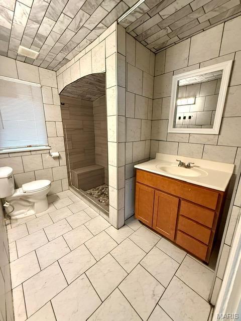 19 S Schlueter Ave, Saint Louis, MO 63135 - full bathroom with tile walls, a tile shower, vanity, and tile patterned floors