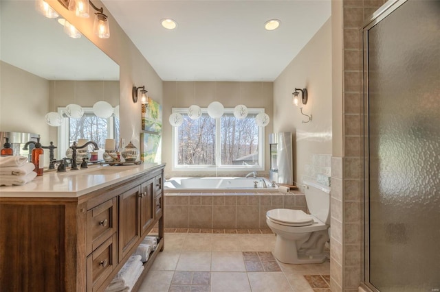 bathroom with a garden tub, tiled shower, vanity, tile patterned floors, and toilet