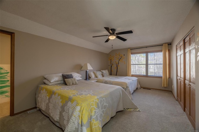bedroom featuring light carpet, baseboards, and a ceiling fan