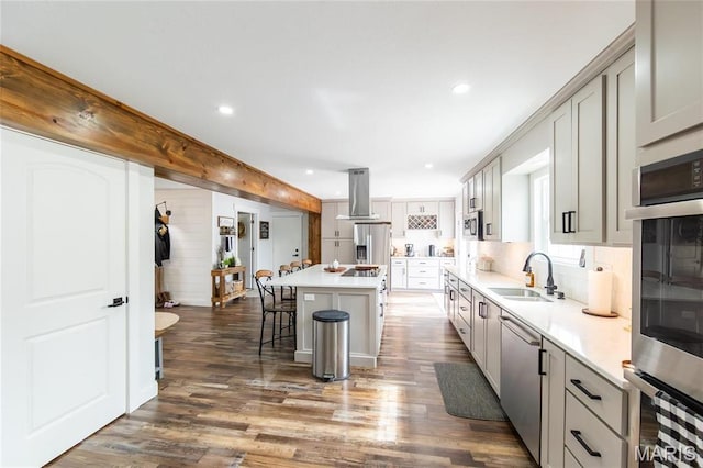 11720 County Road 5160, Rolla, MO 65401 - kitchen featuring a sink, exhaust hood, a breakfast bar, stainless steel appliances, and dark wood-style floors