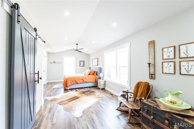 11720 County Road 5160, Rolla, MO 65401 - bedroom featuring a barn door, lofted ceiling, wood finished floors, baseboards, and ceiling fan