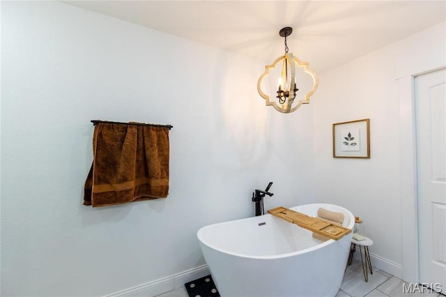 11720 County Road 5160, Rolla, MO 65401 - full bathroom featuring a chandelier, baseboards, a freestanding bath, and tile patterned floors