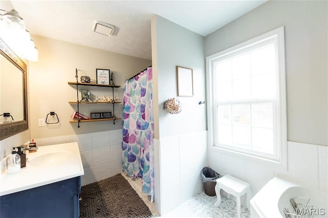 11720 County Road 5160, Rolla, MO 65401 - bathroom featuring tile walls, vanity, curtained shower, and a wainscoted wall