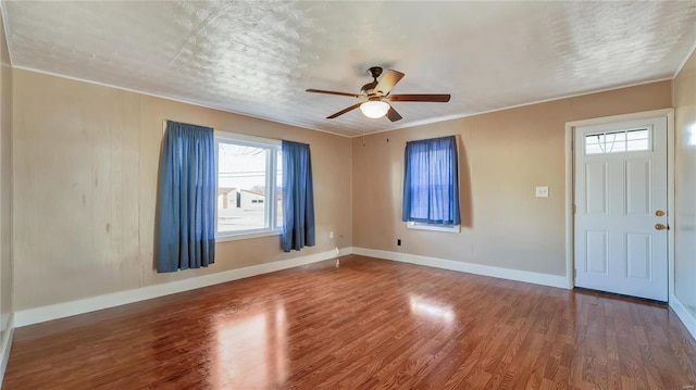 209 W Washington Ave, Richland, MO 65556 - foyer with a ceiling fan, wood finished floors, baseboards, and ornamental molding