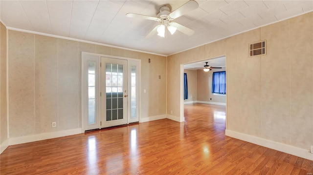 209 W Washington Ave, Richland, MO 65556 - spare room featuring healthy amount of natural light, ceiling fan, ornamental molding, wood finished floors, and baseboards