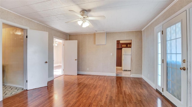 209 W Washington Ave, Richland, MO 65556 - unfurnished room featuring ornamental molding, ceiling fan, wood finished floors, and baseboards