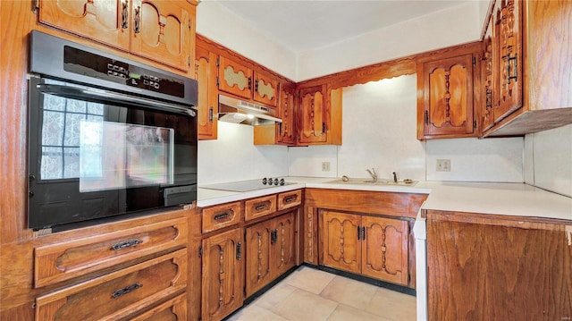 209 W Washington Ave, Richland, MO 65556 - kitchen featuring black appliances, under cabinet range hood, a sink, brown cabinets, and light countertops