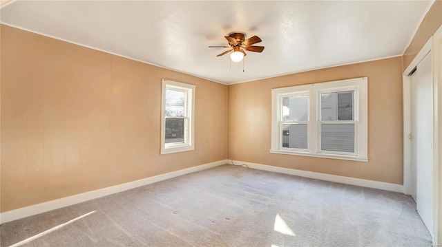 209 W Washington Ave, Richland, MO 65556 - spare room with baseboards, ceiling fan, and light colored carpet