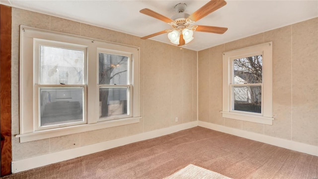 209 W Washington Ave, Richland, MO 65556 - spare room featuring carpet, baseboards, and a ceiling fan