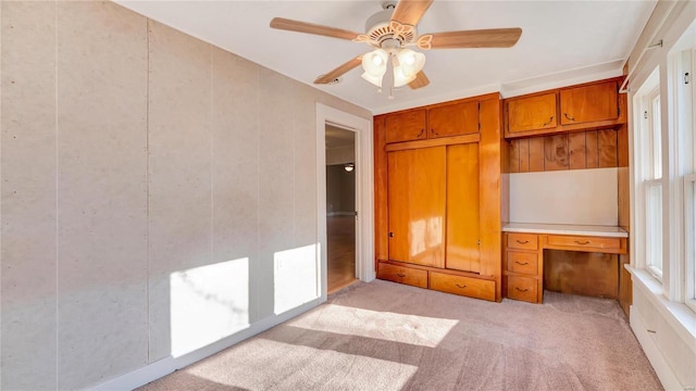 209 W Washington Ave, Richland, MO 65556 - unfurnished bedroom featuring light colored carpet, a desk, and ceiling fan