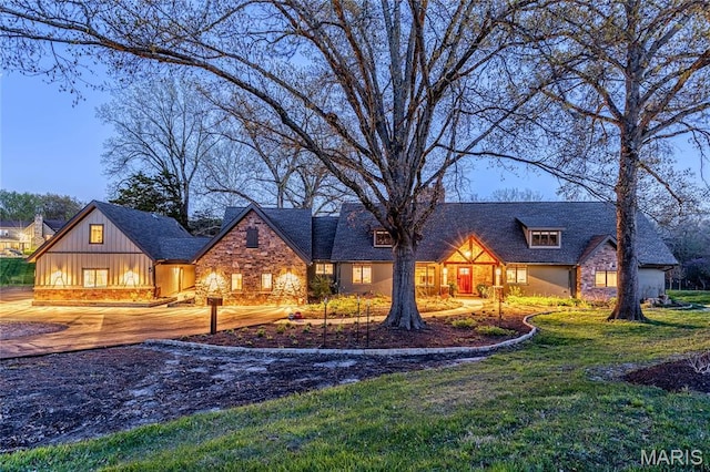 5 Glaizeview Rd, Town And Country, MO 63017 - view of front facade featuring stone siding, a front yard, and board and batten siding