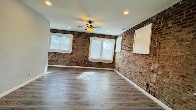 3683 Montana St, Saint Louis, MO 63116 - unfurnished room featuring baseboards, dark wood-style flooring, brick wall, ceiling fan, and recessed lighting