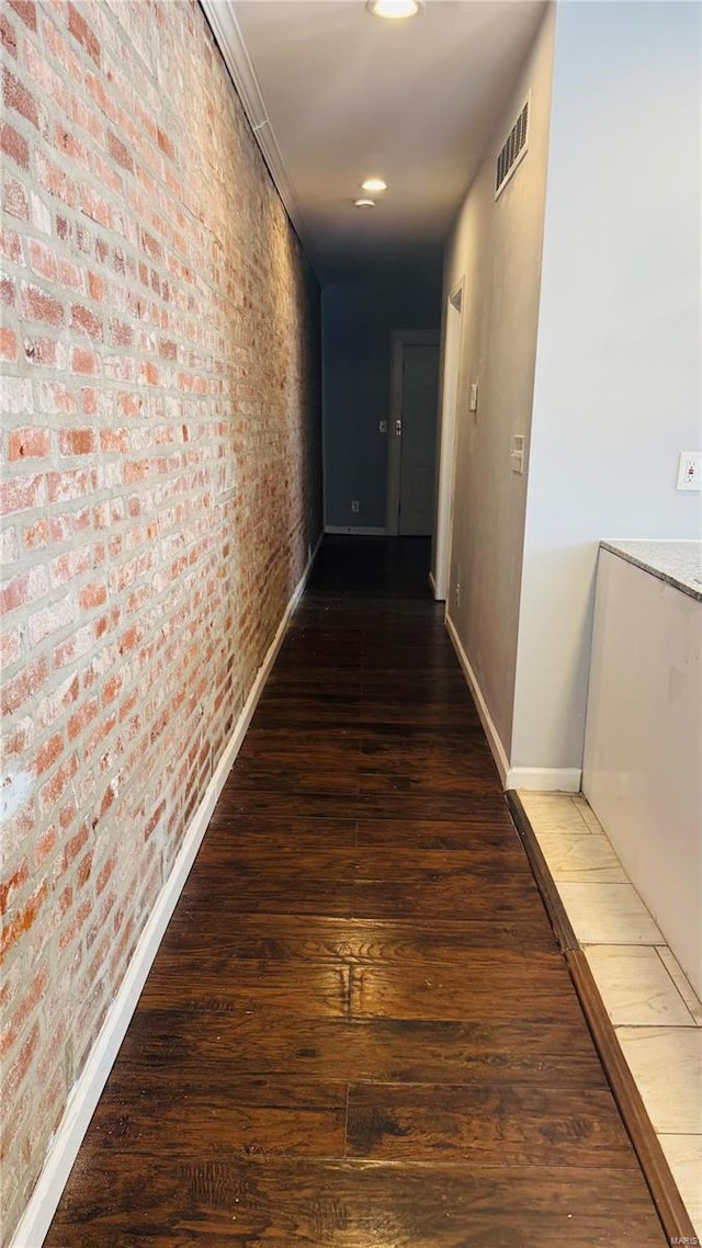 3683 Montana St, Saint Louis, MO 63116 - hall featuring hardwood / wood-style floors, baseboards, brick wall, and recessed lighting