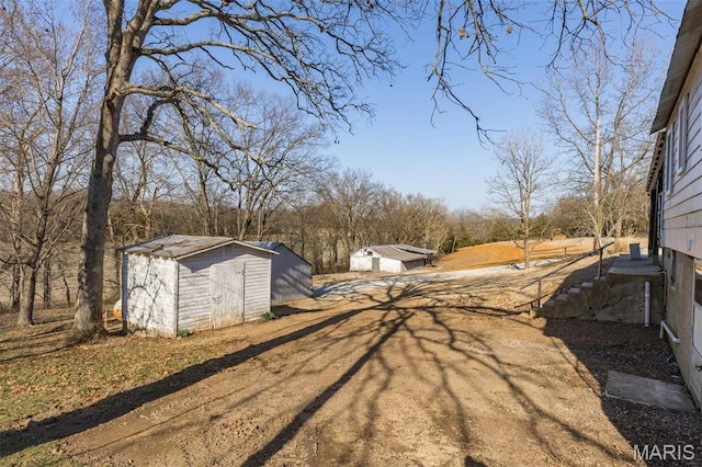 699 Clement Rd, Bloomsdale, MO 63627 - view of yard featuring a shed and an outdoor structure