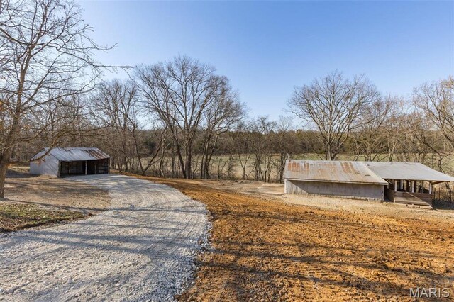 699 Clement Rd, Bloomsdale, MO 63627 - view of dirt / gravel road featuring a pole building