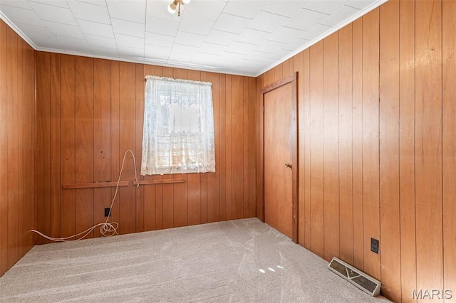 699 Clement Rd, Bloomsdale, MO 63627 - empty room with carpet floors, wood walls, and crown molding