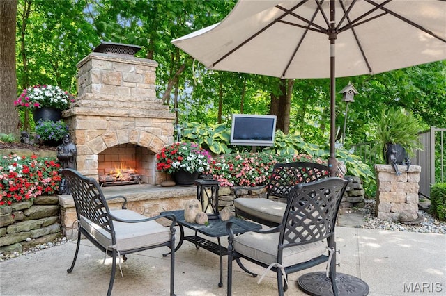 view of patio featuring an outdoor stone fireplace