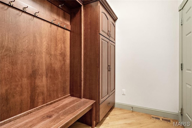 mudroom with light wood-style floors