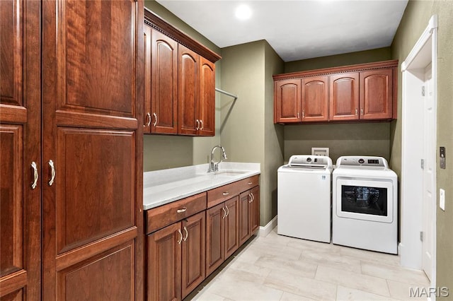 laundry room featuring cabinet space, separate washer and dryer, and baseboards