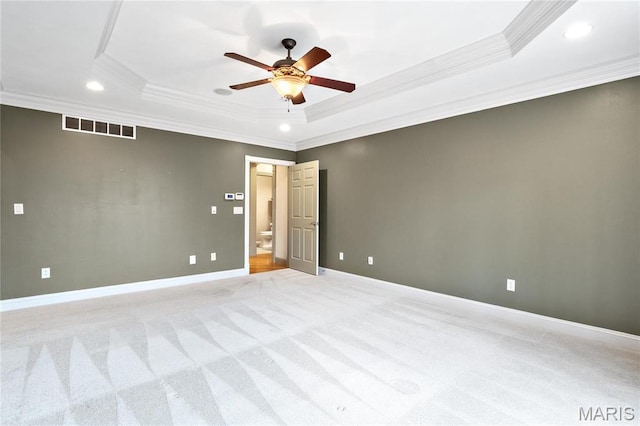 unfurnished room with ornamental molding, a raised ceiling, recessed lighting, ceiling fan, and light colored carpet