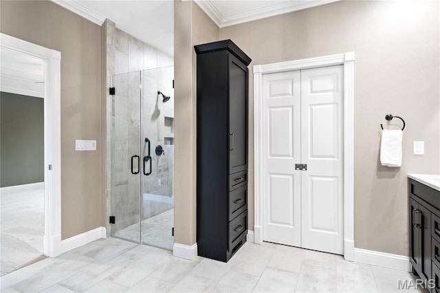 full bath with a stall shower, crown molding, vanity, baseboards, and a closet