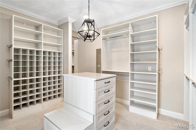 spacious closet featuring a chandelier and light colored carpet