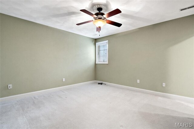 unfurnished room with light carpet, baseboards, and a ceiling fan