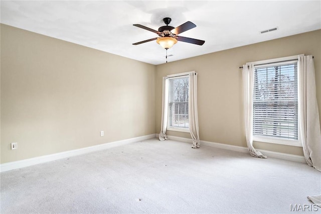 spare room with light carpet, baseboards, and a ceiling fan