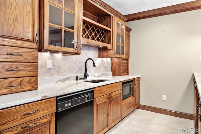 kitchen featuring black appliances, decorative backsplash, baseboards, a sink, and light stone counters