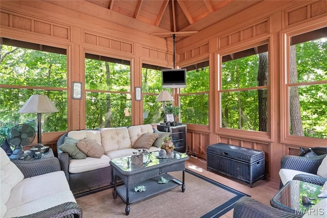 sunroom / solarium featuring vaulted ceiling and an outdoor living space